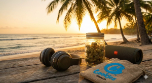 Jamaican beach scene with headphones, cannabis flower, and sunset